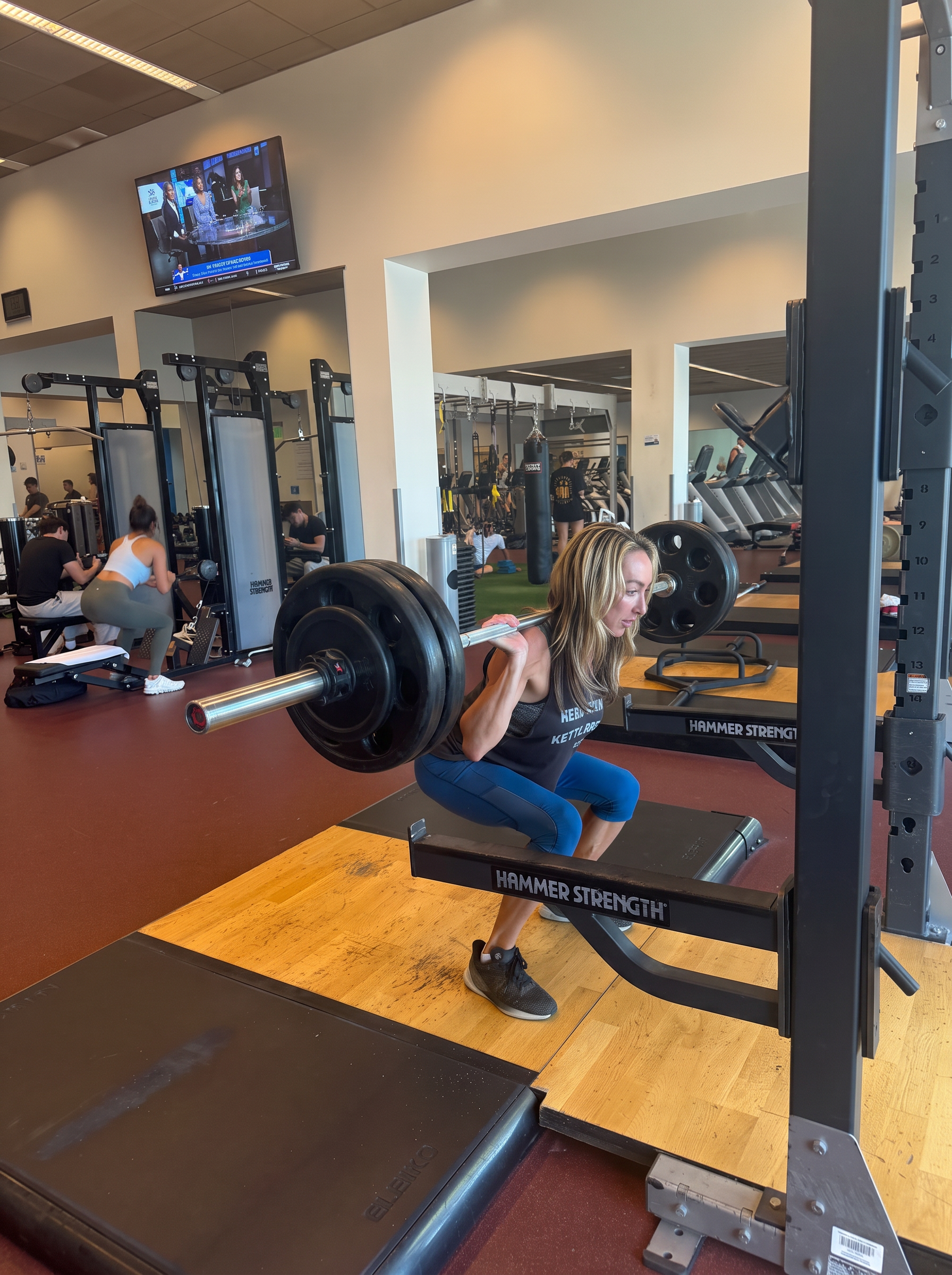 Sarah Haskell performing a barbell back squat in the gym